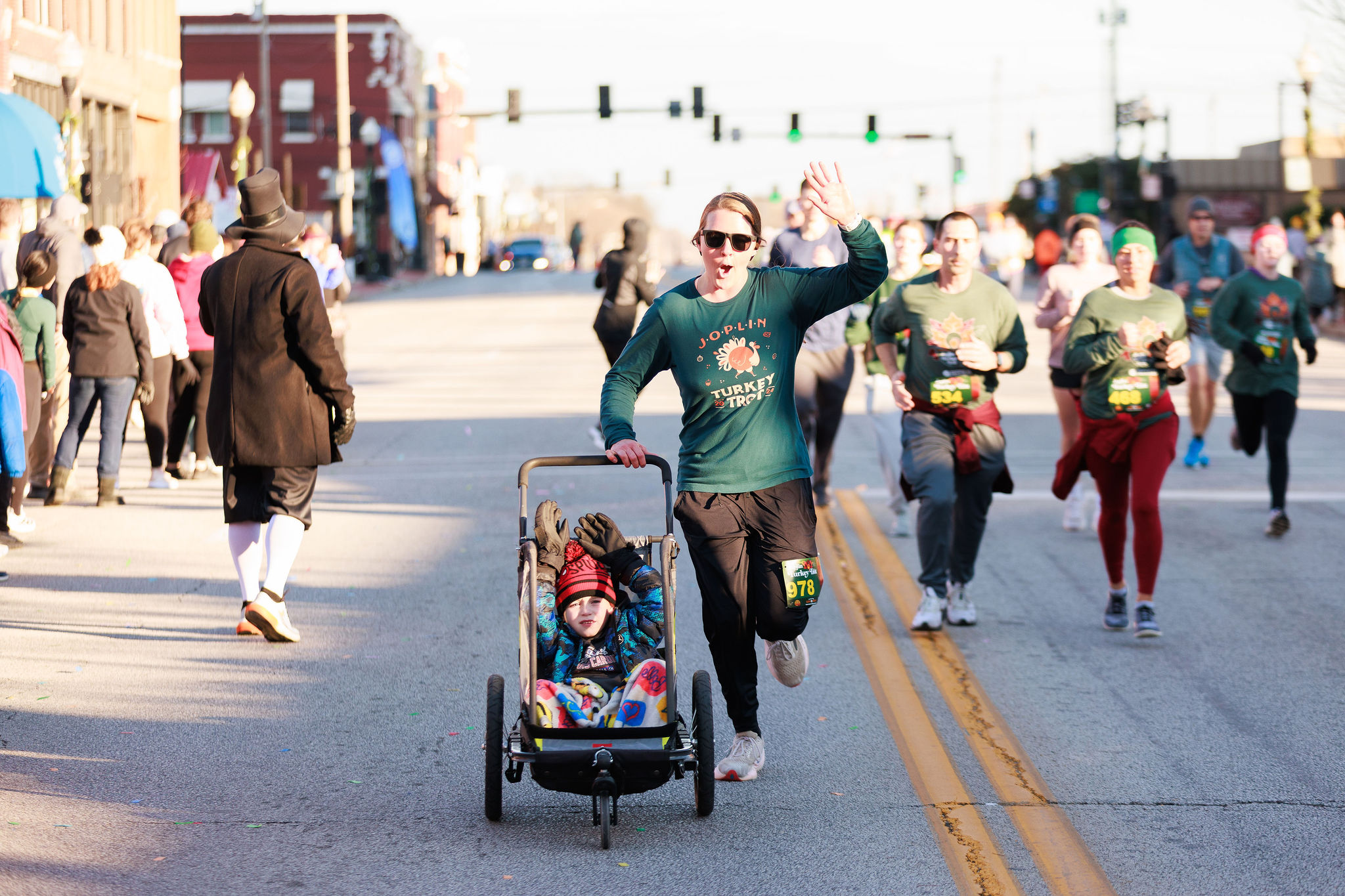 Participant pushing a child in a stroller during the Joplin Turkey Trot 5K in Downtown Joplin.